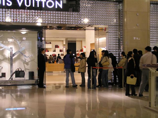 You have to wait in line to get into Luis Vuitton these days!
